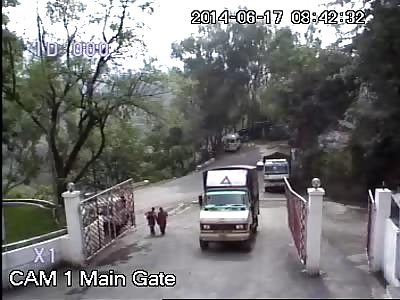 A truck losses control and slides down in reverse falling down the ravine. 