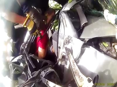 CORPSE BEING REMOVED FROM THE DEBRIS OF A CAR ACCIDENT