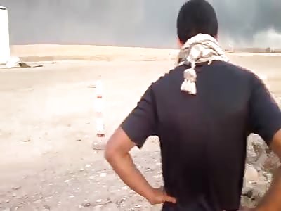 GROUP OF MEN HANGING DEAD ENEMY UPSIDE DOWN ON A POLE