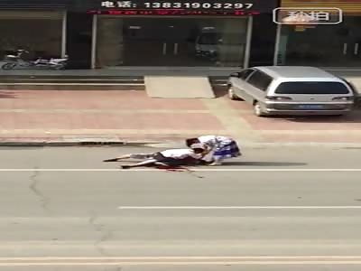 Enraged Husband Stabs Wife's Lover to Death on the Street in Broad Daylight as She Begs Him to Stop